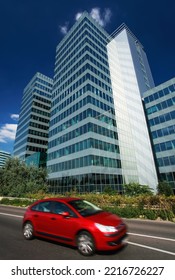 Modern Office Building Exterior In City With Red Car