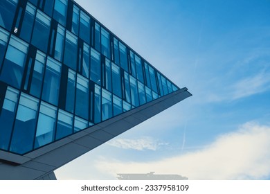 Modern office building exterior with glass facade on clear sky background. Transparent glass wall of office building. Element of facade of modern European building Commercial office buildings - Powered by Shutterstock