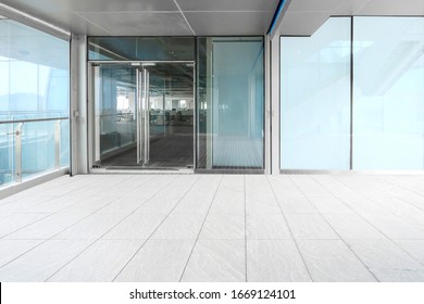 A Modern Office Building With Glass Doors And Windows