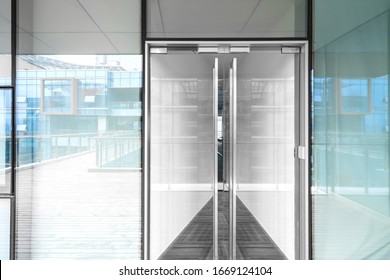 A Modern Office Building With Glass Doors And Windows