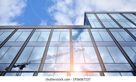 Modern office building with glass facade on a clear sky background. Transparent glass wall of office building. - Shutterstock ID 1936067137