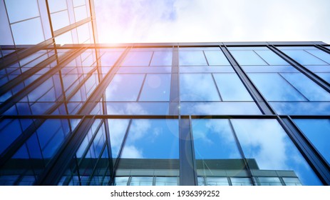 Modern office building with glass facade on a clear sky background. Transparent glass wall of office building. - Shutterstock ID 1936399252