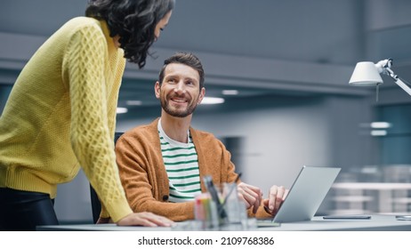 Modern Office: Business Meeting of Two Businesspeople Talking at the Desk. Businessman and Businesswoman Work on Strategy, Brainstorm for e-Commerce Software Design. Shot with Motion Blur Background