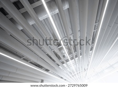 Modern office ceiling with linear lights and acoustic panels