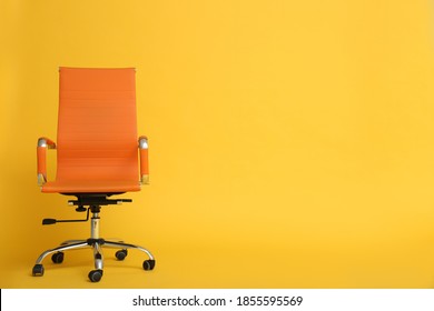 Modern office chair on yellow background. Space for text