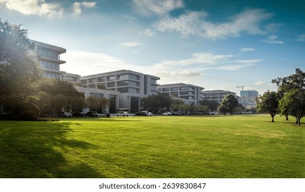 Modern Office Complex Surrounded by Lush Greenery Under Bright Blue Sky  