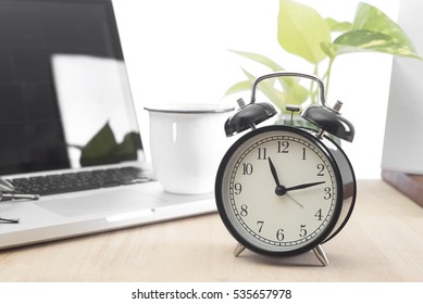 Modern Office desk with alarm clock. alert deadline concept. - Powered by Shutterstock