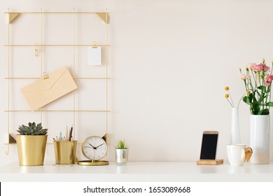 Modern office desk with gold accessories. Empty space, mock up. Minimal style.