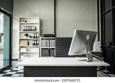 A modern office desk with a laptop, monitor, and plant. sleek, minimal design features open space, technology and productivity. room is empty, offering a clean and organized workspace.