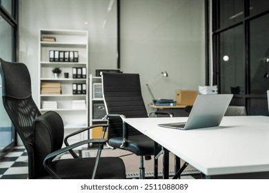 A modern office desk with a laptop, monitor, and plant. sleek, minimal design features open space, technology and productivity. room is empty, offering a clean and organized workspace.