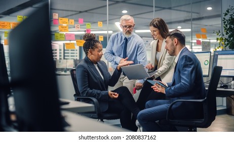 In Modern Office: Diverse Team of Managers Use Laptop and Tablet Computers at a Company Meeting Discussing Business Projects. Young, Motivated and Experienced Employees Brainstorm in Conference Room. - Shutterstock ID 2080837162