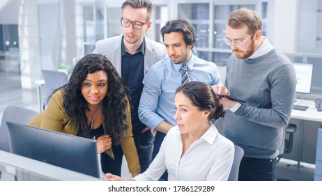 In Modern Office: Diverse Team of Young Motivated Businessmen and Businesswoman Work on Computer, Having Discussion, Finding Problem Solution Collectively. Ambitious Businesspeople Successful Teamwork - Shutterstock ID 1786129289
