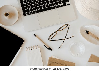 Modern Office Essentials. Laptop, Pen, Notebook, and Glasses Arranged on a White Desk. Efficiency and Style - Powered by Shutterstock