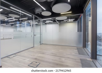 Modern Office With Glass Walls, Light Laminate Flooring And Large Windows. Without Furniture.