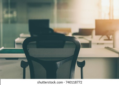 Modern office interior with black chairs and white furniture in morning day.
