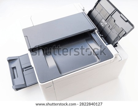 A modern office laser printer is isolated on a clean white background