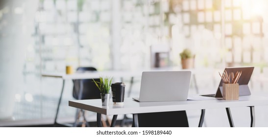 Modern Office Room With Office Supplies On Table With Office Environment In The Background