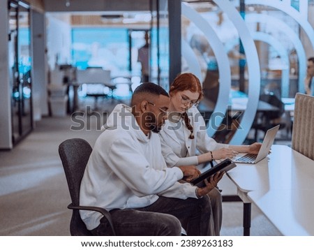 In a modern office setting, an African American businessman and his Muslim colleague, wearing a hijab, engage in collaborative discussions, tackling various business tasks and solving problems