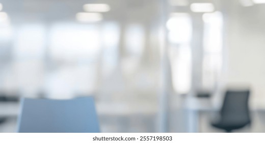 Modern office space with a blurred focus on a blue chair. - Powered by Shutterstock