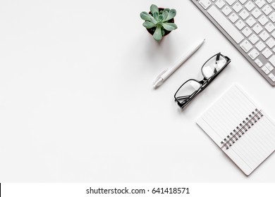 Modern office table with keyboard, glasses, notebook on white background top view mock-up - Shutterstock ID 641418571