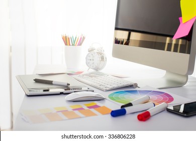 Modern office workplace with digital tablet, notepad, colorful pencils, glasses, in morning - Shutterstock ID 336806228