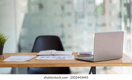 Modern office workspace with laptop, documents, and a chair. Ideal for business, productivity, and professional themes. - Powered by Shutterstock