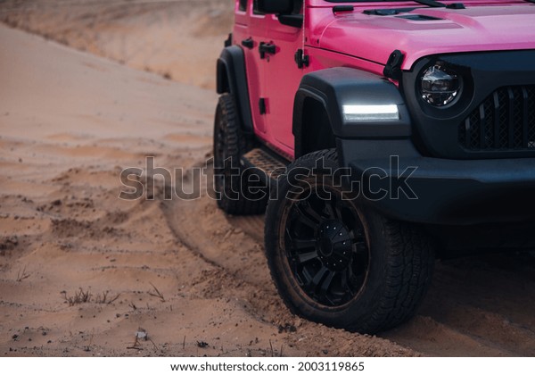 Modern\
off-road car in the middle of the desert. Car stuck in sands during\
the off-road trip. Front-wheel of pick up\
car