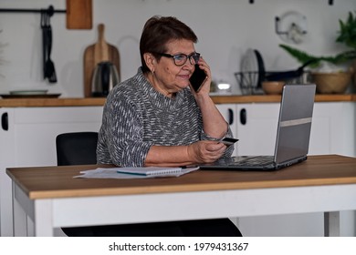 Modern Old Cheerful Lady Using Online Banking. Frustrated Senior Woman Yelling At The Bank Clerk, Dissatisfied With Her Credit Card Balance.