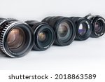 Modern and old DSLR camera lens set on white background
