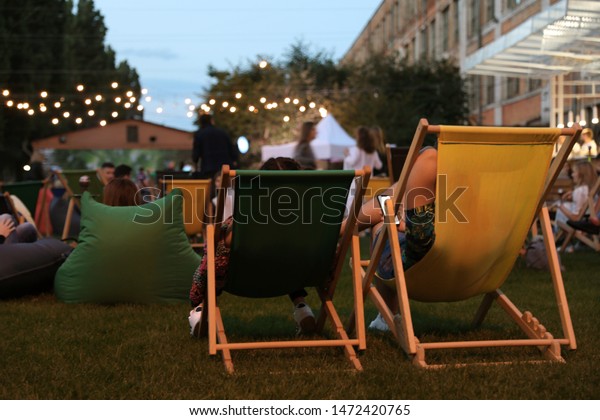 Modern open air cinema with comfortable seats in\
public park