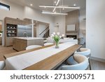 modern open concept kitchen dining interior residential high end house long wooden table stainless steel appliances white countertop sputnik lighting fixture pantry minimalist contemporary design