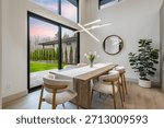 modern open concept kitchen dining interior residential high end house long wooden table stainless steel appliances white countertop sputnik lighting fixture pantry minimalist contemporary design