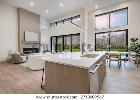 modern open concept kitchen dining interior residential high end house long wooden table stainless steel appliances white countertop sputnik lighting fixture pantry minimalist contemporary design