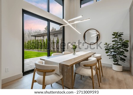 modern open concept kitchen dining interior residential high end house long wooden table stainless steel appliances white countertop sputnik lighting fixture pantry minimalist contemporary design
