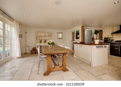 Modern open plan kitchen dining room with traditional decor and furniture