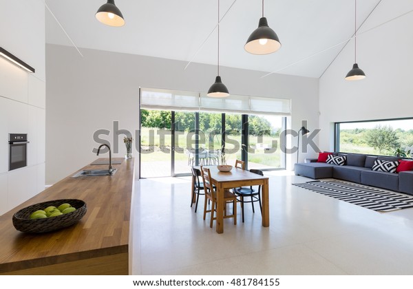 Modern open\
plan project house with dining table\
