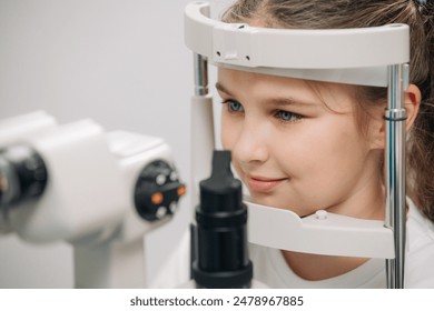 In a modern ophthalmology clinic, a small patient undergoes vision diagnostics. In the interior of a modern clinic. The concept of vision correction and diagnostics at an early age. - Powered by Shutterstock