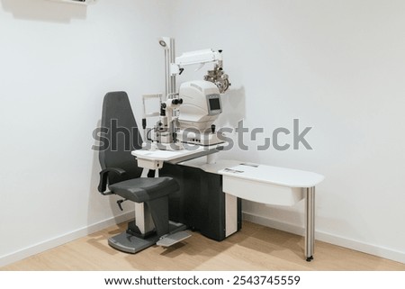 Modern optometry equipment standing in empty exam room