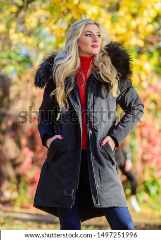 Modern outfit for youth. Girl in warm coat stand in park nature background defocused. Woman long blonde hair wear stylish outfit with parka. Create fall outfit to feel comfortable and pretty.