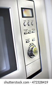 Modern oven control panel close up with buttons and knob close up of a modern kitchen