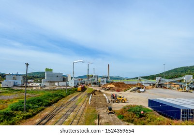 Modern Paper Mill Factory In Maine With Trucks And Railroad In Foreground 