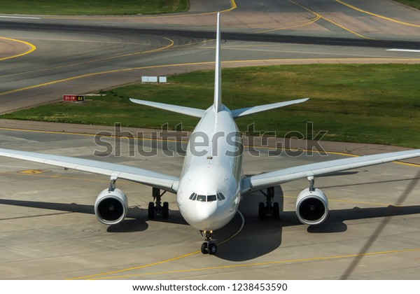Modern passenger civil airplane taxiing at\
international airport