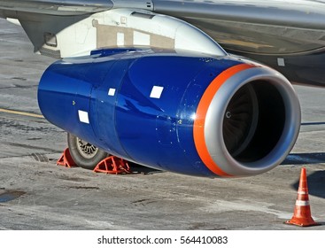 Modern Passenger Jet Airplane Parked With Aircraft Parts Jet Engine Intake Nacelle Leading Edge Wing Slats Gear Wheel Tire Close Up Exterior Airport Reflections Sunny Maintenance Background View