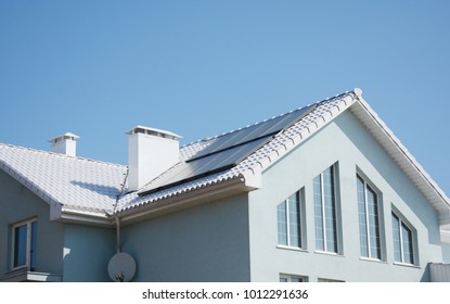 Modern passive house with white roof and solar panels for energy saving and energy efficiency. - Shutterstock ID 1012291636