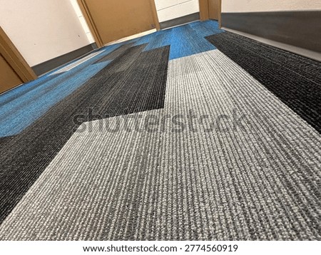 Modern patterned carpet flooring interior showing geometric design and commercial flooring texture detail