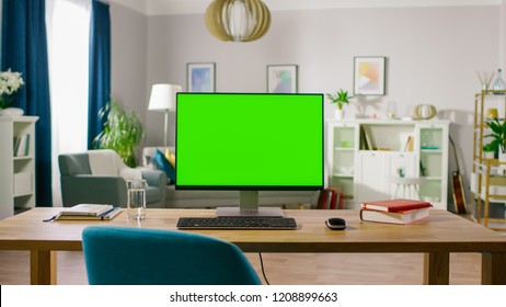 Modern Personal Computer With Mock-up Green Screen Display Standing On The Desk Of The Cozy Home Office. Living Room Of Stylish Interior Designer.