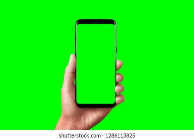 Modern Phone In Hand Isolated. Chroma Key For Video Mockup Presentation.