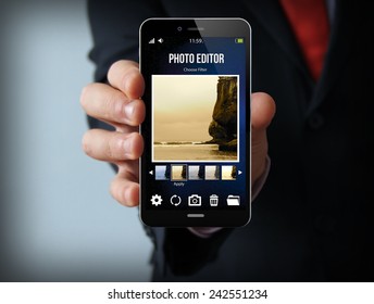 modern photography concept: businessman holding a photo editor smartphone