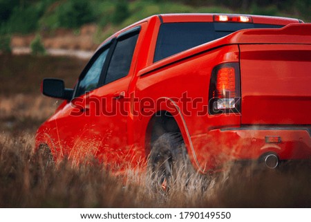 Modern pickup in the middle of the desert. Car at the offroad. Big red truck stopped at the during off-road trip