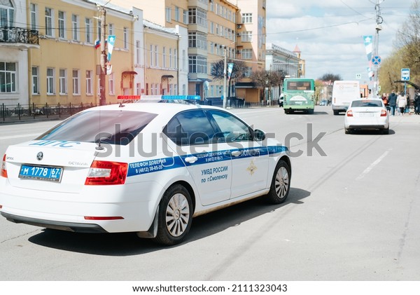 Modern\
police car with shining light signals standing on road in city\
street during day. Smolensk, Russia\
9.05.2021